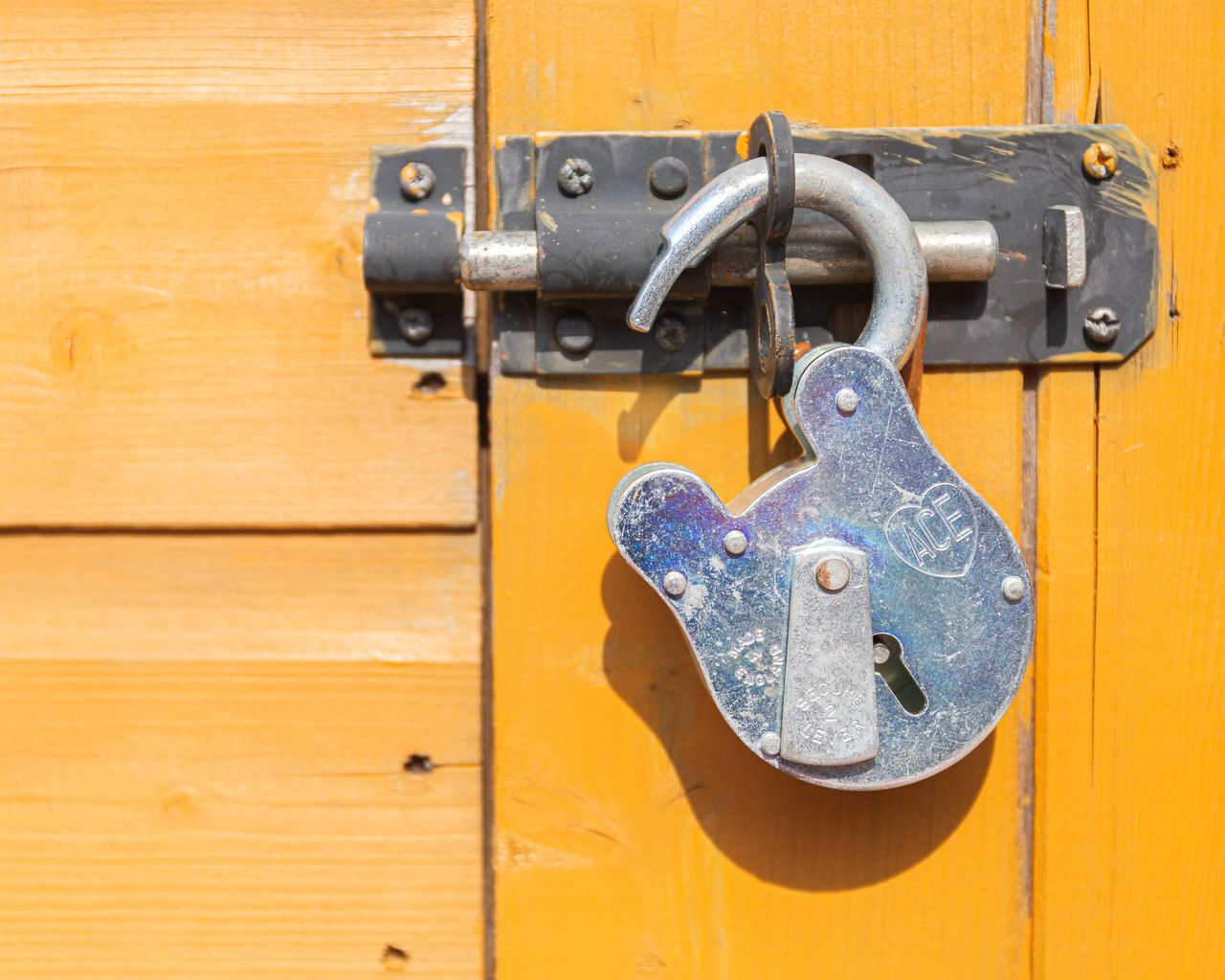 open lock hanging from a door