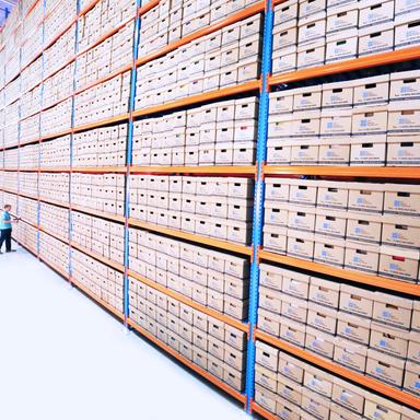 boxes of documents stacked in a warehouse